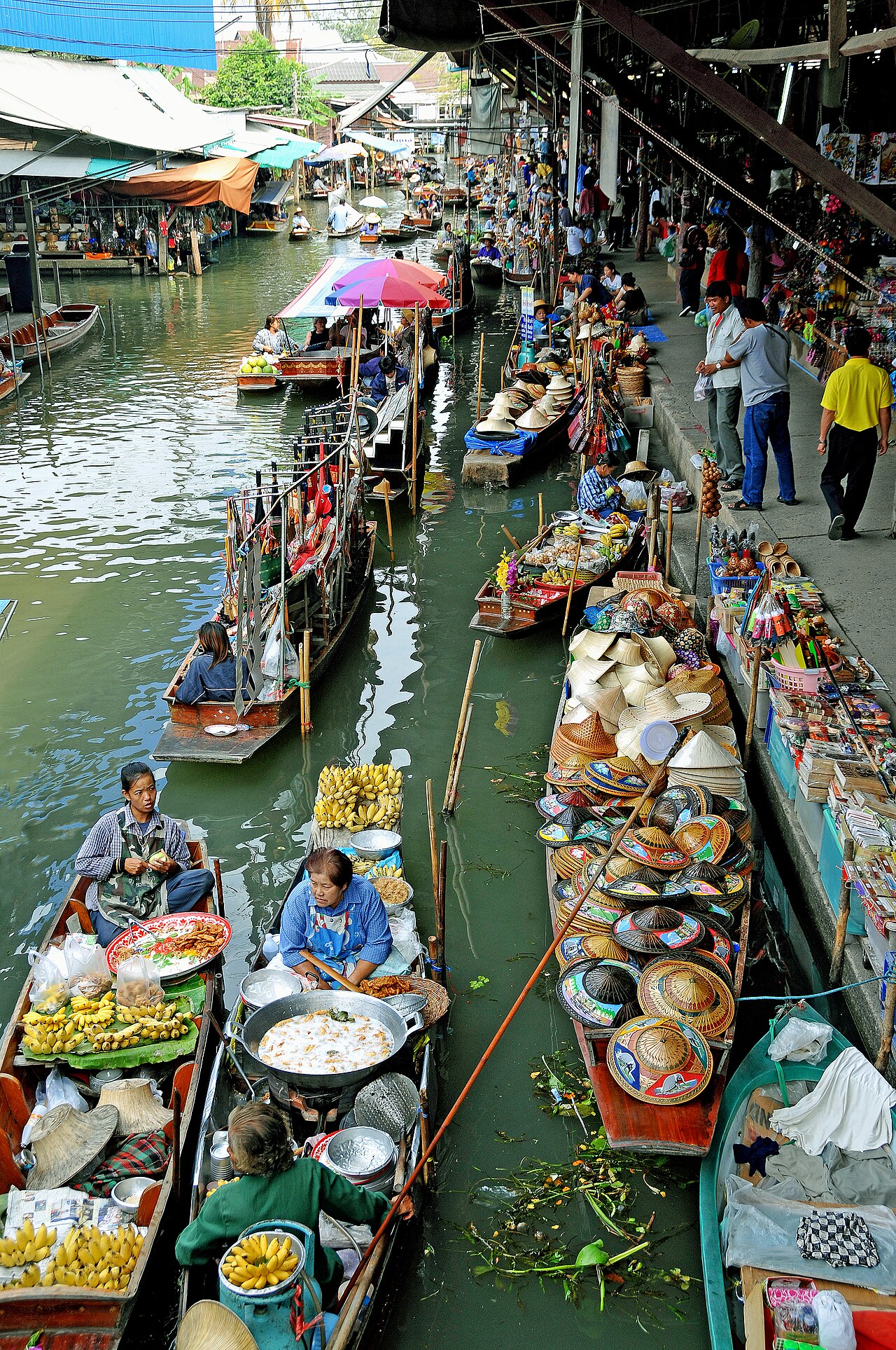 Floating market boats selling fruit and food in a canal